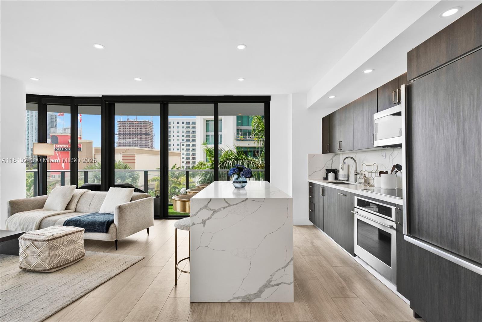 121 Northeast 34th Street, Unit L304 Miami, FL 33137 - Photo 9 of 36 a living room with furniture and a large window