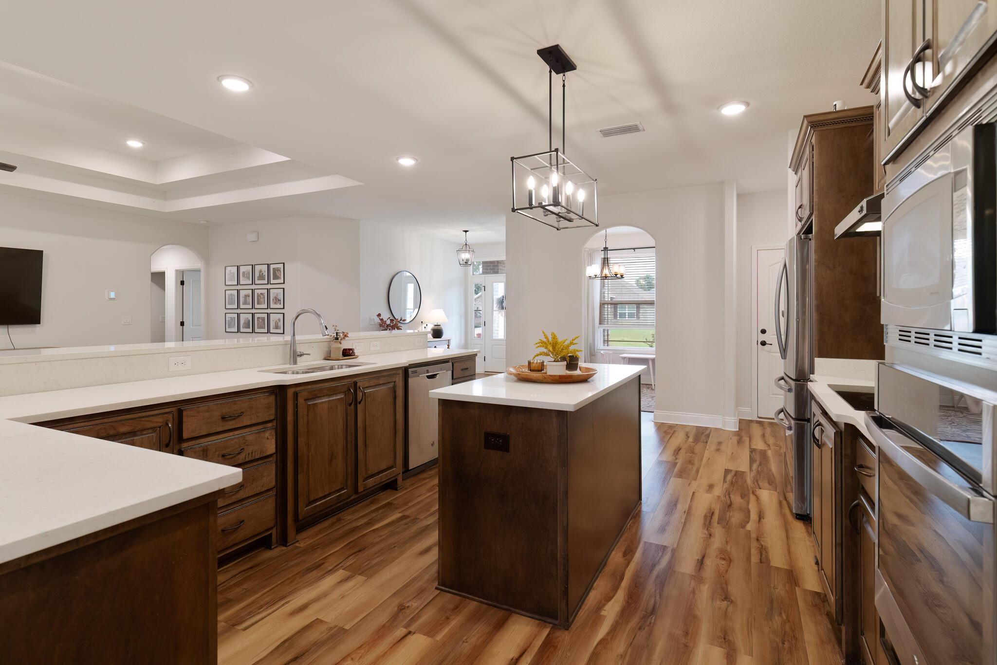 9180 Tara Circle Milton, FL 32583 - Photo 15 of 56 a kitchen with stainless steel appliances granite countertop a sink a stove and a wooden floors