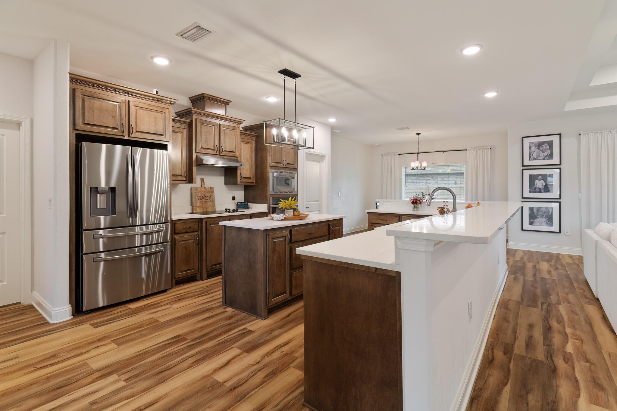 9180 Tara Circle Milton, FL 32583 - Photo 20 of 56 a kitchen with refrigerator cabinets and wooden floor