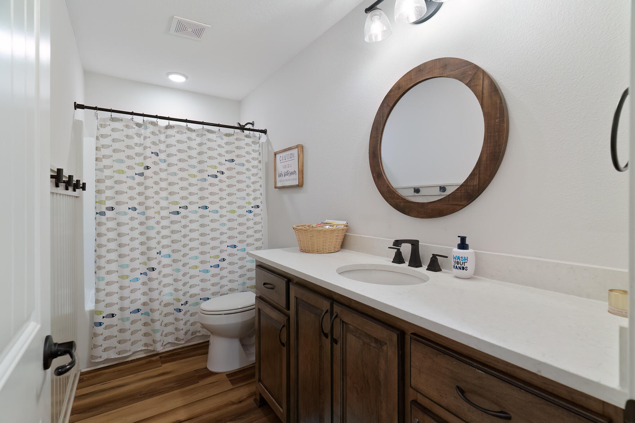 9180 Tara Circle Milton, FL 32583 - Photo 39 of 56 a bathroom with a sink a toilet and a mirror