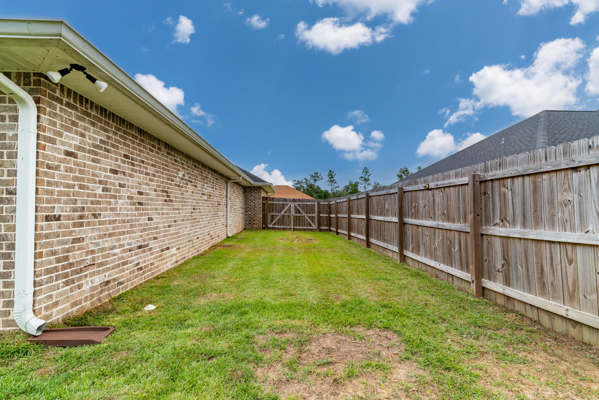 9180 Tara Circle Milton, FL 32583 - Photo 49 of 56 a view of a backyard with brick wall
