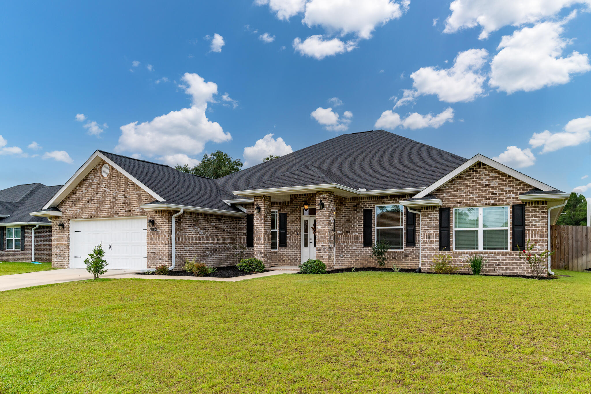 9180 Tara Circle Milton, FL 32583 - Photo 5 of 56 a front view of a house with garden