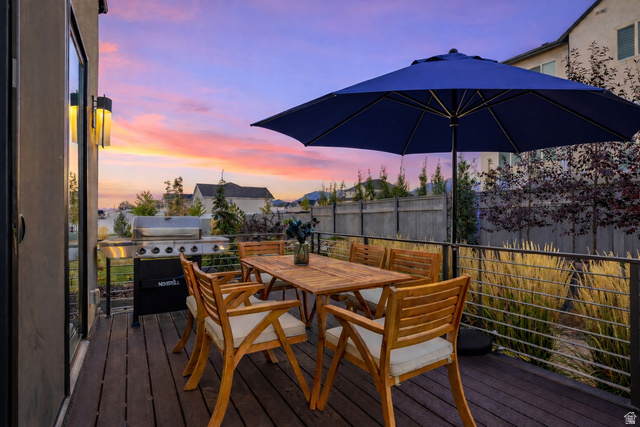 11617 South Wildrye Field Way Draper, UT 84020 - Photo 42 of 53 Deck at dusk featuring outdoor dining area and area for grilling