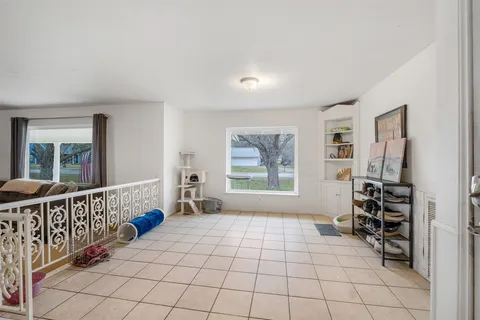 a living room with furniture a ceiling fan and a window