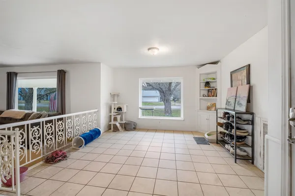 a living room with furniture a ceiling fan and a window