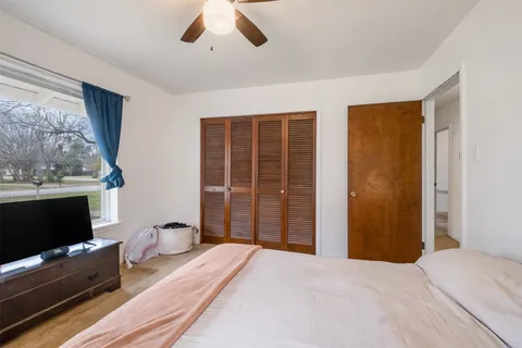 a spacious bedroom with a bed and a walk in closet
