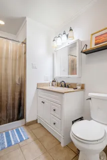 a bedroom with a large bed and a flat screen tv