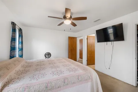 a bedroom with a bed and a tv
