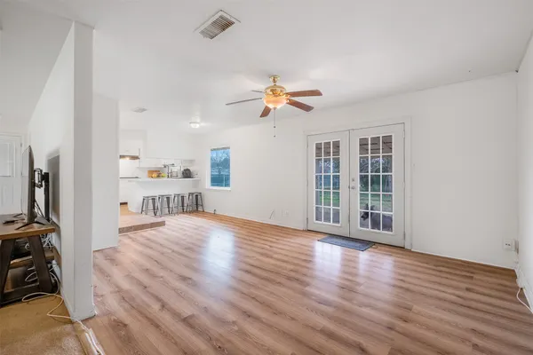a view of empty room with wooden floor
