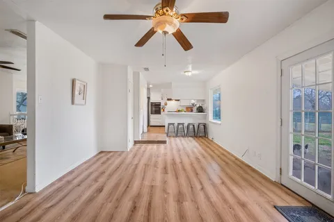 a dining room with stainless steel appliances a dining table chairs and a refrigerator