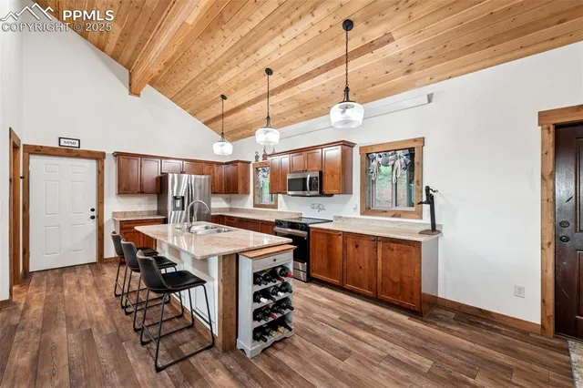 a open kitchen with stainless steel appliances granite countertop a stove and refrigerator