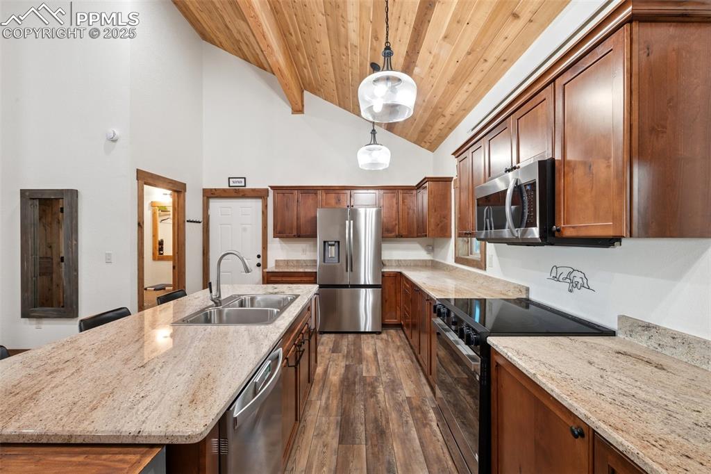 103 Copper Mountain Drive Cripple Creek, CO 80813 - Photo 10 of 29 a large kitchen with stainless steel appliances granite countertop plenty wooden cabinets counter space and wooden floor