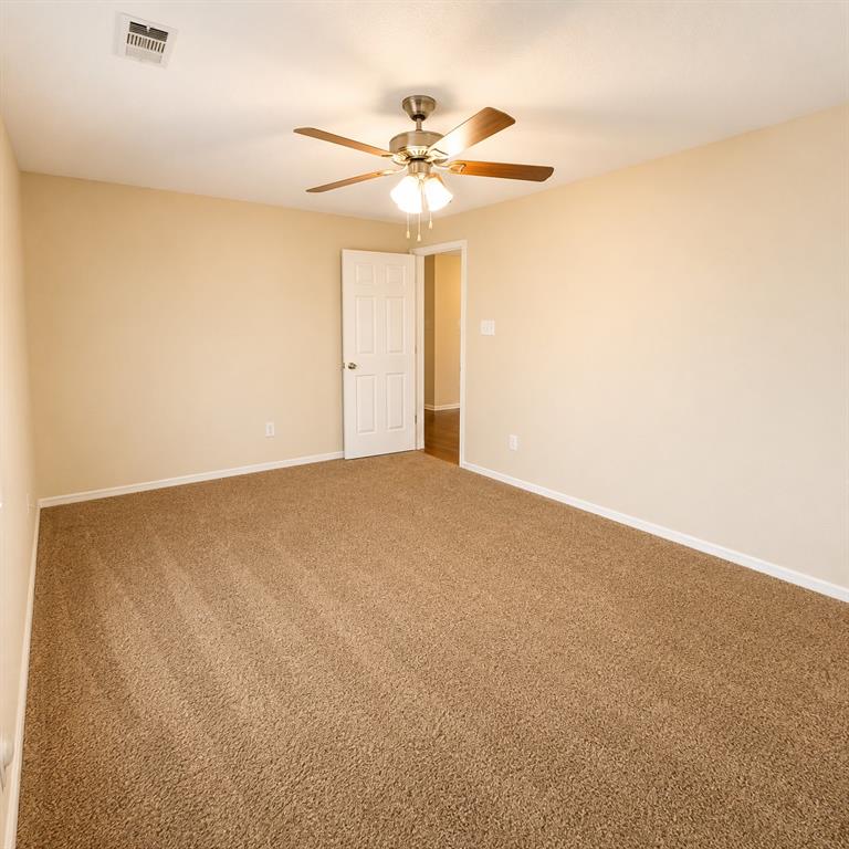 2003 Firefly Circle Waco, TX 76705 - Photo 17 of 29 Spacious room featuring neutral wall paint, brown carpet flooring, and a ceiling fan with integrated lighting