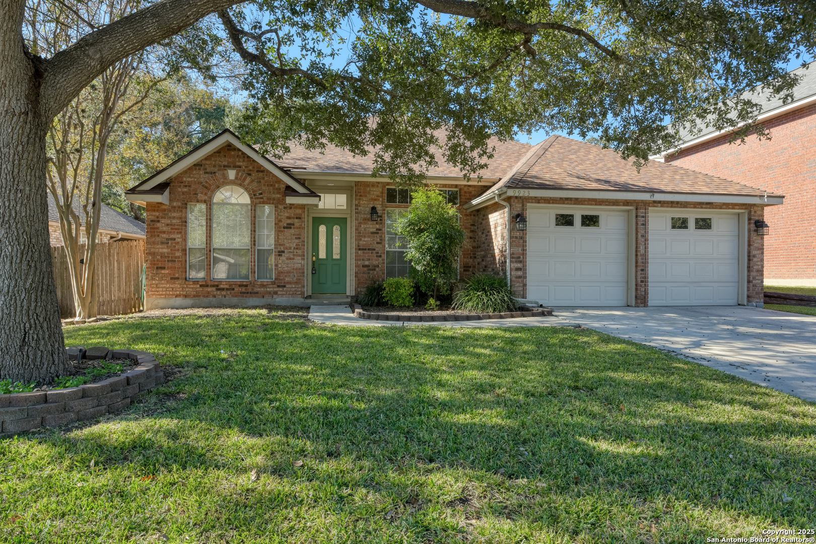 9923 Tezel Road San Antonio, TX 78254 - Photo 1 of 30 a front view of a house with a yard and garage