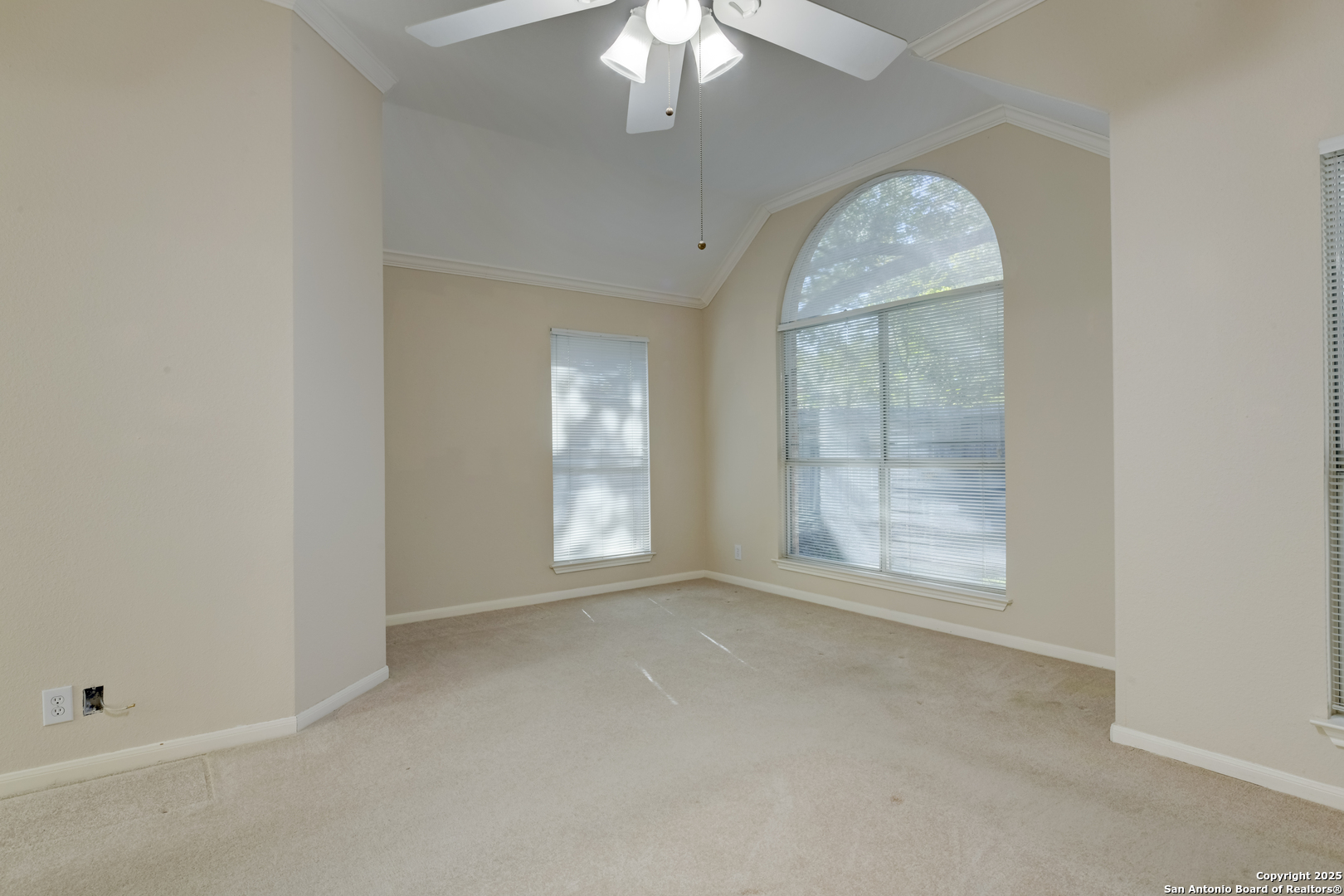 9923 Tezel Road San Antonio, TX 78254 - Photo 14 of 30 an empty room with a chandelier fan and windows