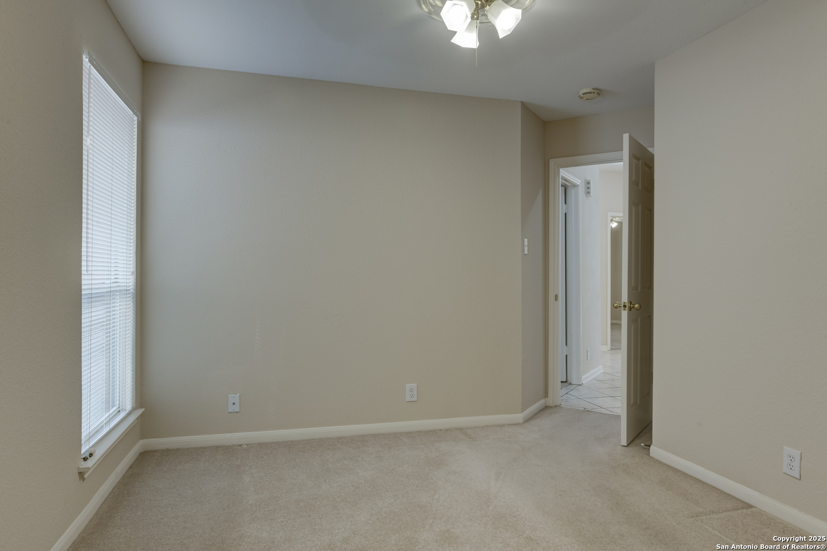 9923 Tezel Road San Antonio, TX 78254 - Photo 25 of 30 an empty room with a windows and chandelier fan