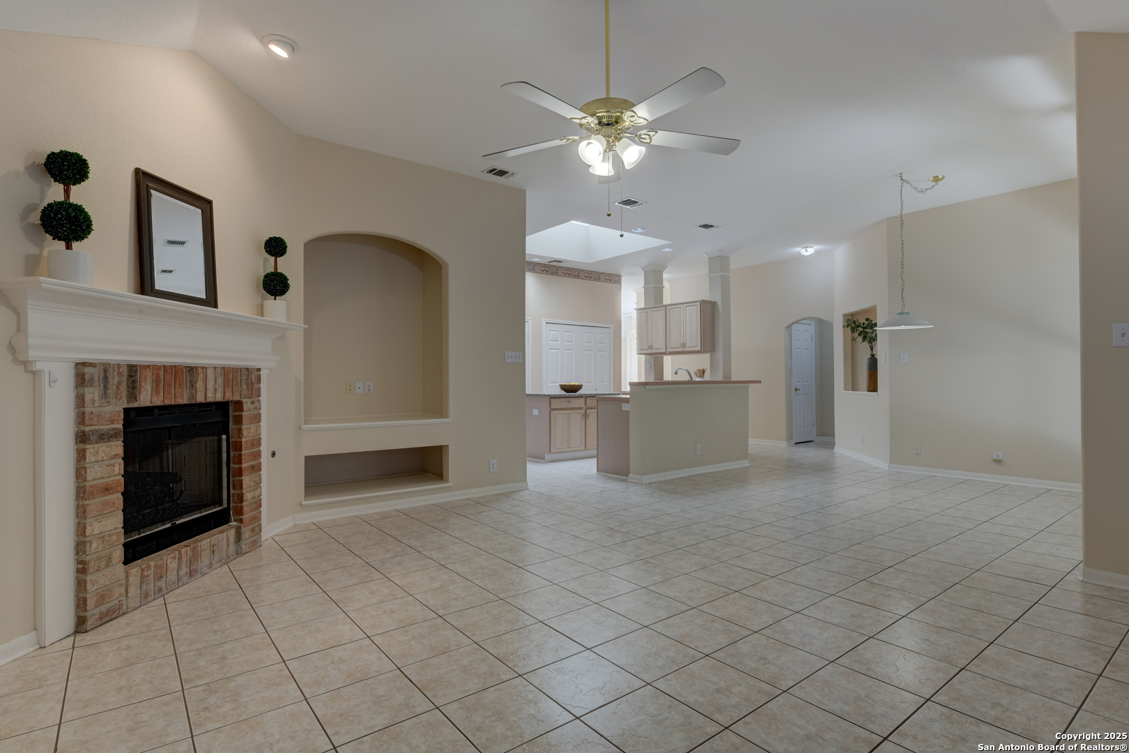9923 Tezel Road San Antonio, TX 78254 - Photo 10 of 30 a view of a kitchen with a sink and a fireplace