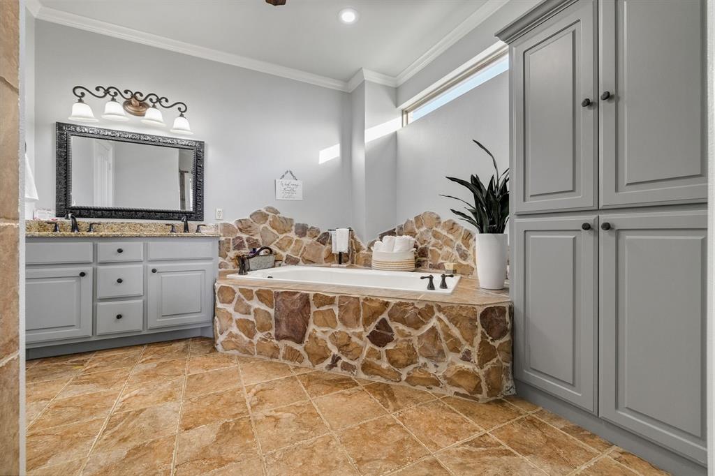 689 Jim Cannon Road Van Alstyne, TX 75495 - Photo 21 of 35 Full bathroom with ornamental molding, double vanity, and a garden tub