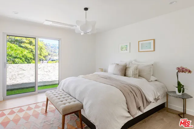 a spacious bedroom with a bed and a table