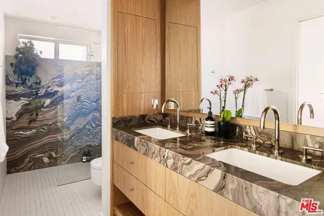 a bathroom with a toilet and a shower curtain