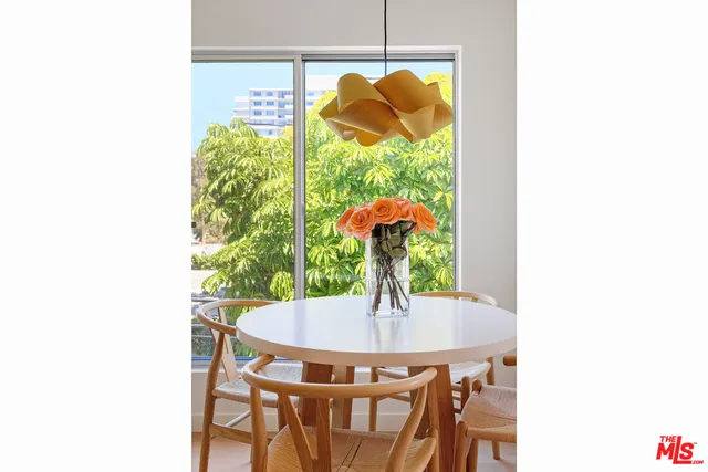 a dining room with table and chairs