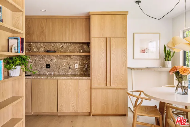 a kitchen with stainless steel appliances granite countertop a sink and a refrigerator