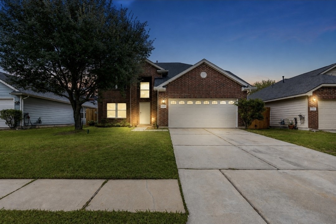 11430 Moonlight Ridge Drive Humble, TX 77396 - Photo 2 of 15 a front view of a house with a garden