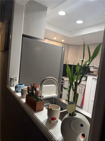 a bathroom with a sink a potted plant and a mirror