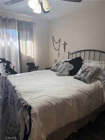 a bedroom with a bed and window