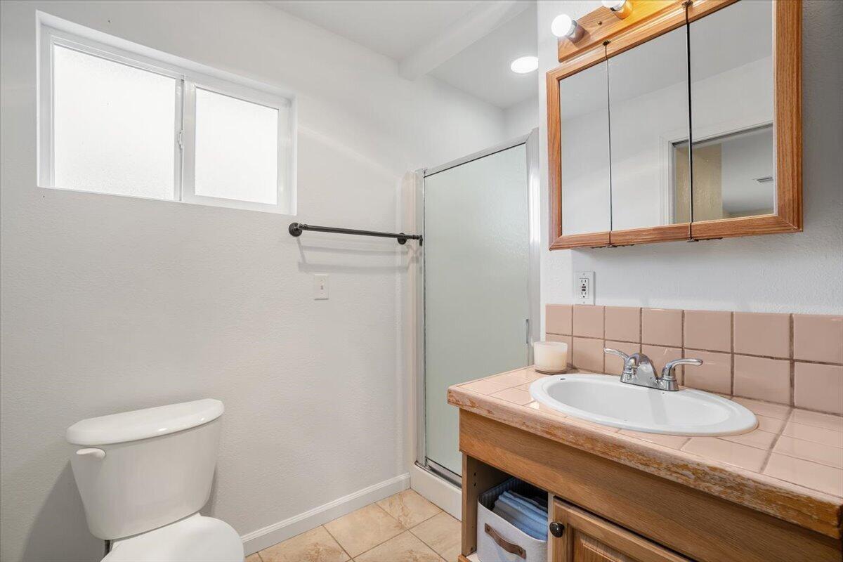 1196 Freshwater Road Eureka, CA 95503 - Photo 19 of 34 a bathroom with a granite countertop sink and a toilet