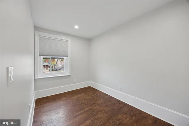 a view of a room with wooden floor and window