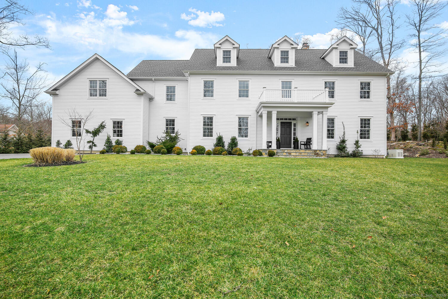 5 Smith Ridge Road Weston, CT 06883 - Photo 1 of 1 a view of a white house with a big yard and large trees