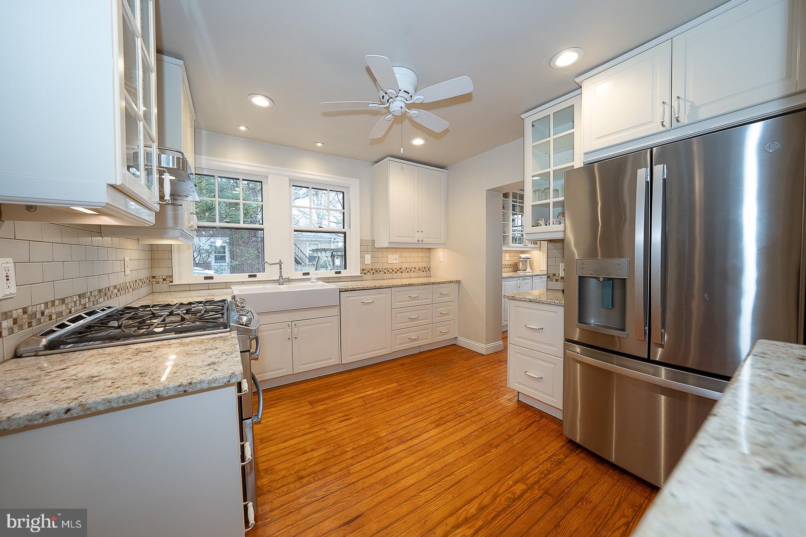124 Grandview Road Ardmore, PA 19003 - Photo 18 of 65 a kitchen with stainless steel appliances granite countertop a refrigerator a sink a stove and white cabinets with wooden floor