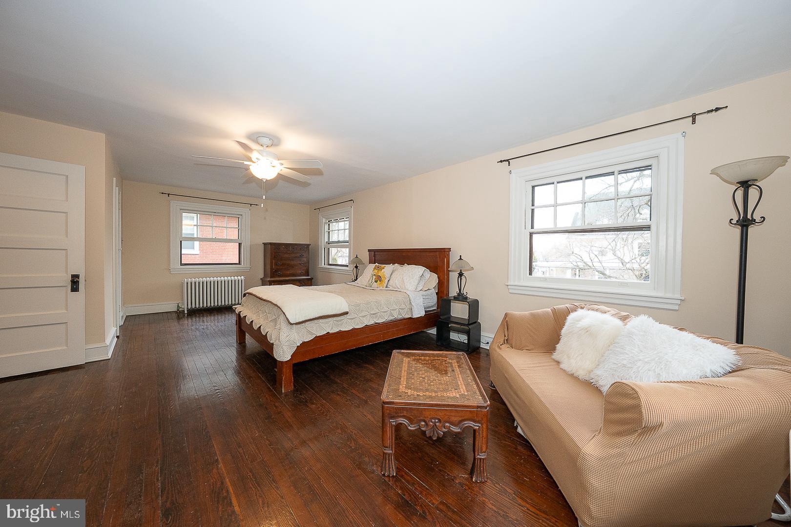 124 Grandview Road Ardmore, PA 19003 - Photo 32 of 65 a bedroom with a bed wooden floor and window