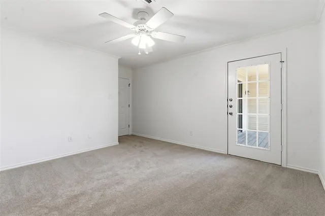an empty room with a chandelier fan