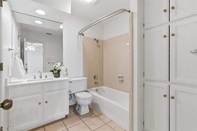 a bathroom with a bathtub shower sink vanity and mirror