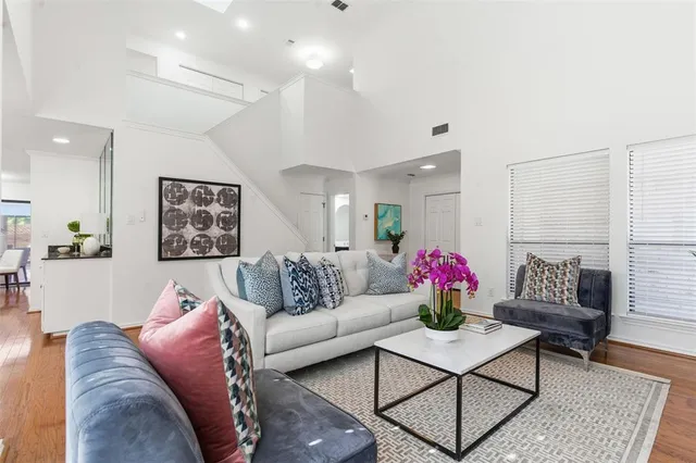 a living room with furniture and wooden floor