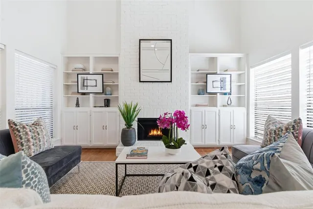 a living room with furniture and flowers