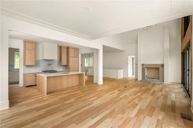 a large kitchen with granite countertop a stove and cabinets