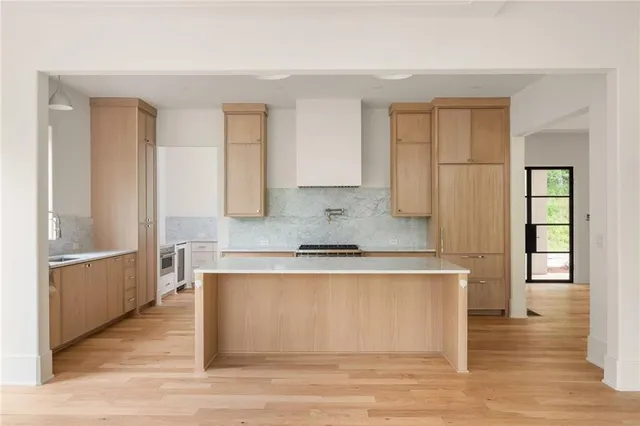 a kitchen with stainless steel appliances granite countertop a stove a sink and a refrigerator