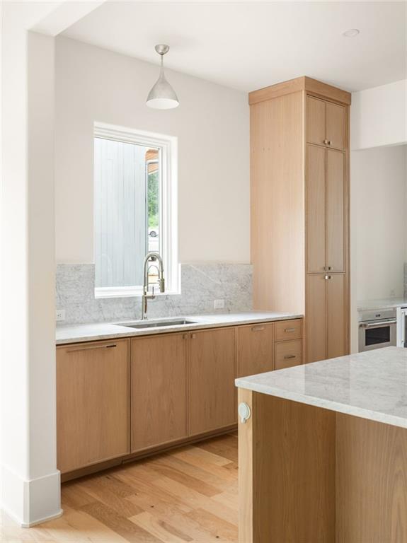 1064 Lupo Loop Chattahoochee Hills, GA 30268 - Photo 15 of 40 a kitchen with granite countertop a sink and a window