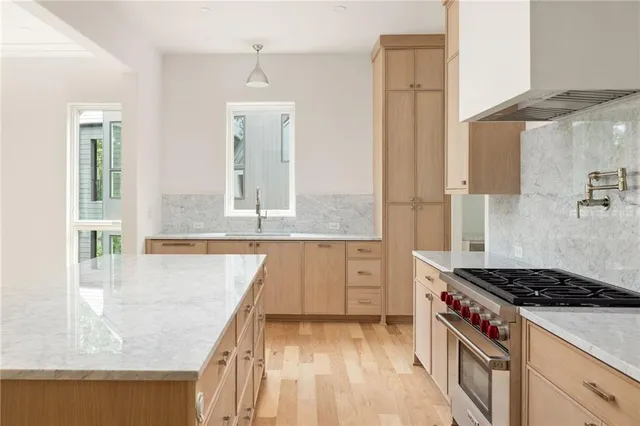 a kitchen with granite countertop a stove and a sink