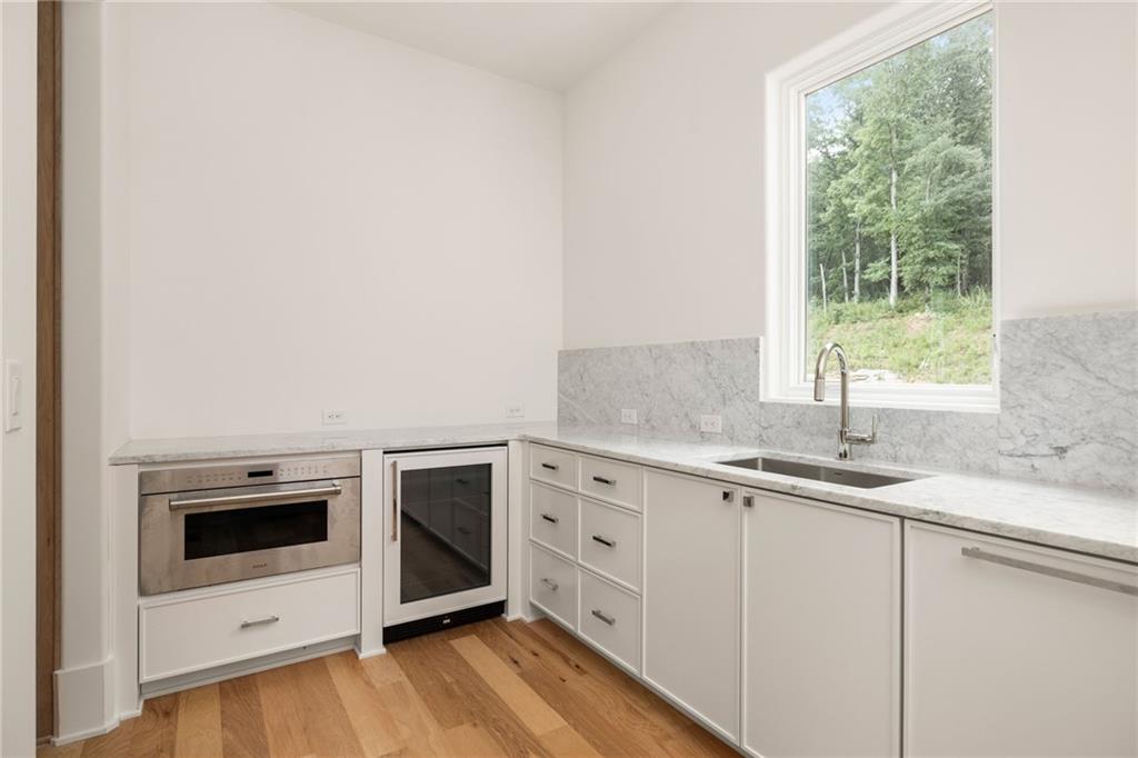 1064 Lupo Loop Chattahoochee Hills, GA 30268 - Photo 19 of 40 a kitchen with a sink stove and cabinets