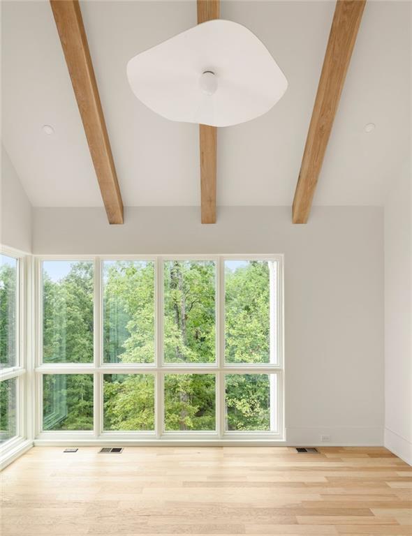 1064 Lupo Loop Chattahoochee Hills, GA 30268 - Photo 21 of 40 a view of a room with wooden floor and windows
