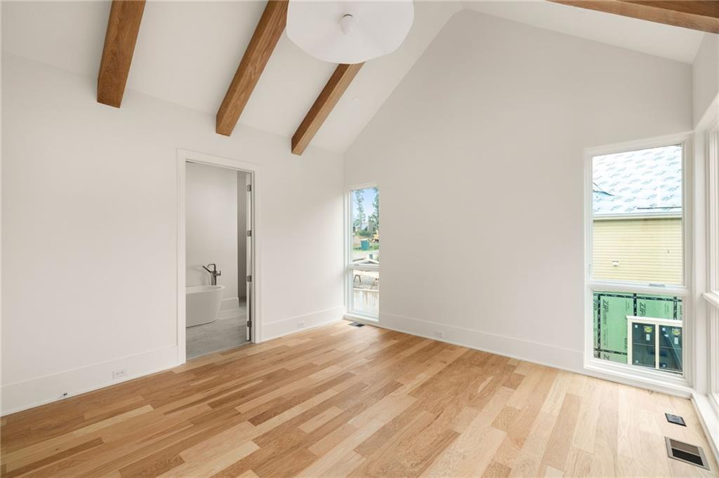 1064 Lupo Loop Chattahoochee Hills, GA 30268 - Photo 22 of 40 a view of empty room with wooden floor and fan