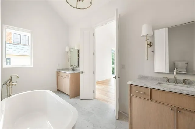 a bathroom with a tub sink and mirror
