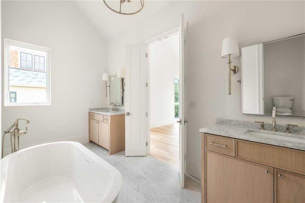 1064 Lupo Loop Chattahoochee Hills, GA 30268 - Photo 23 of 40 a bathroom with a tub sink and mirror