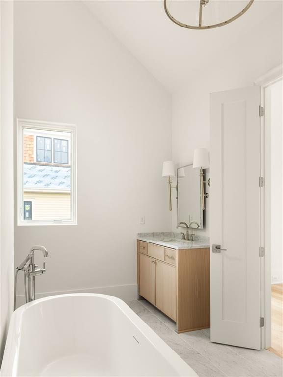 1064 Lupo Loop Chattahoochee Hills, GA 30268 - Photo 24 of 40 a bathroom with a sink a bathtub and a window