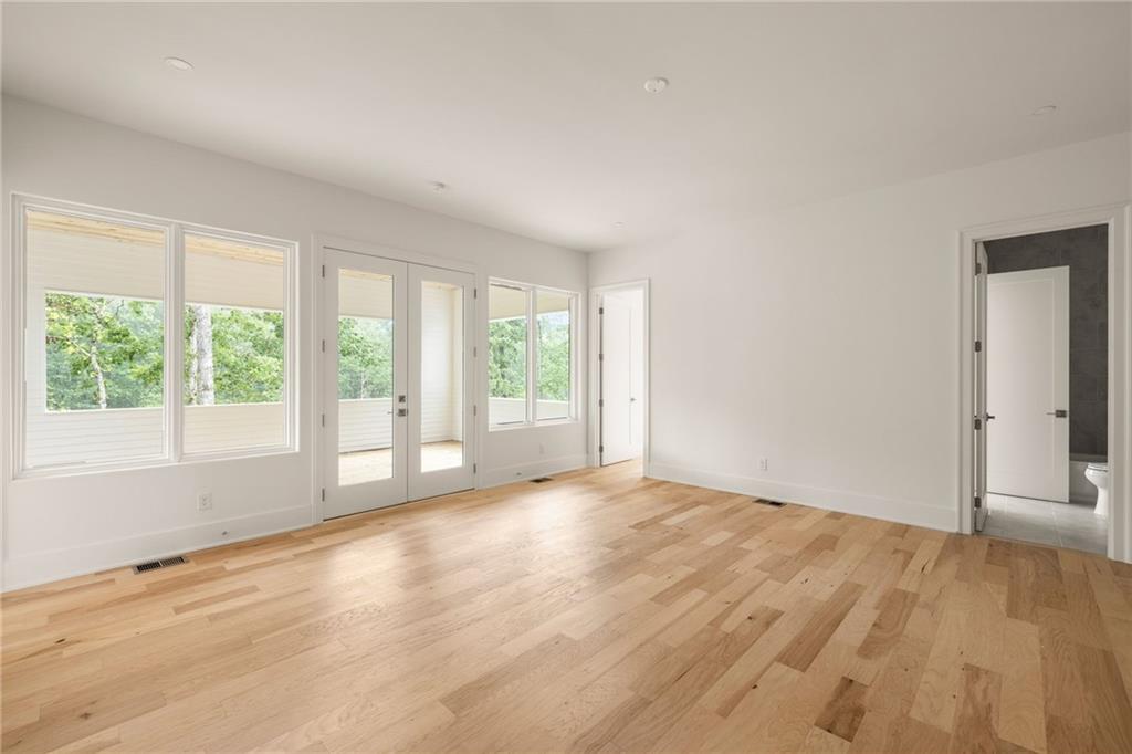 1064 Lupo Loop Chattahoochee Hills, GA 30268 - Photo 28 of 40 a view of an empty room with wooden floor and a window