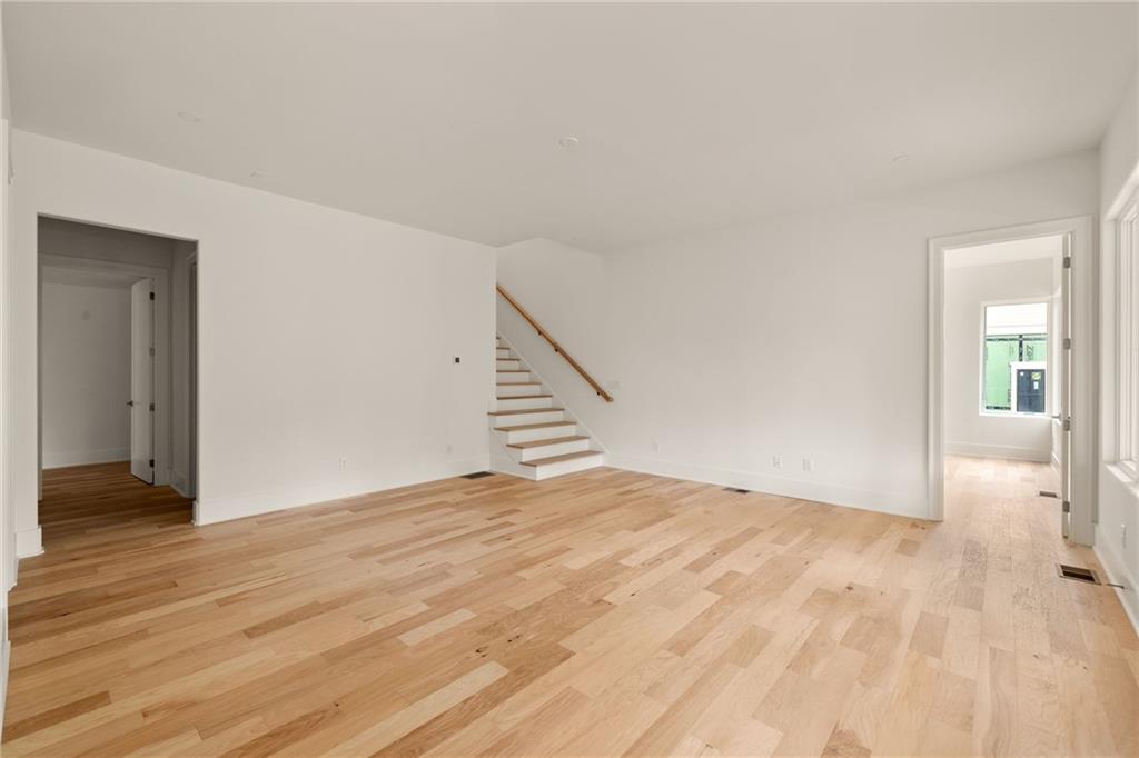 1064 Lupo Loop Chattahoochee Hills, GA 30268 - Photo 29 of 40 a view of an empty room with wooden floor